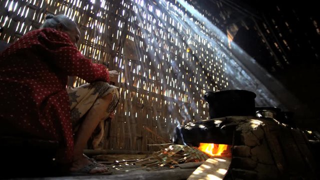 Traditional cooking in pots by senior Indonesian female indoors Java 