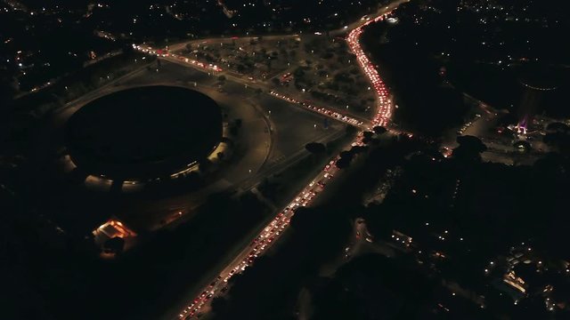 Timelapse - Aerial night view of the EUR District in Rome. Orbit Around the Sports Hall, and large avenues full of car traffic