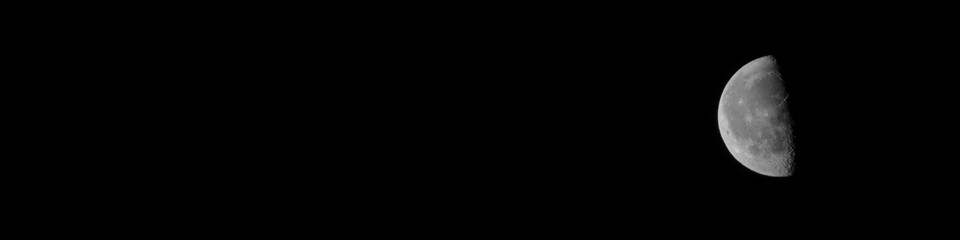 Half Moon background in black and white. The Moon is an astronomical body that orbits planet Earth