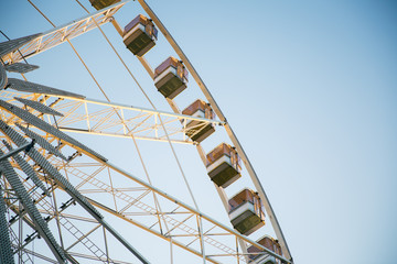 Low angle view of a ferris wheel with blue sky background 