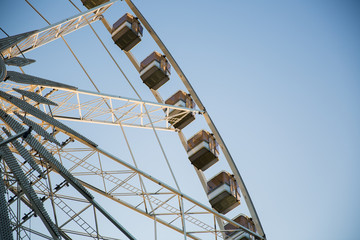 Low angle view of a ferris wheel with blue sky background 