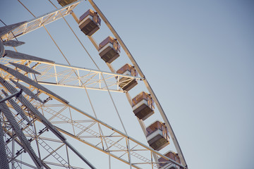 Low angle view of a ferris wheel with blue sky background 