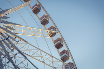 Low angle view of a ferris wheel with blue sky background 