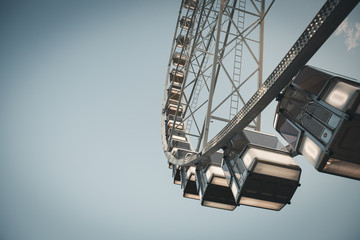Low angle view of a ferris wheel with blue sky background 