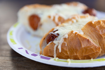 Hot dog with cheese on top