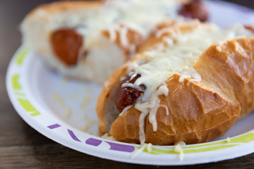 Hot dog with cheese on top