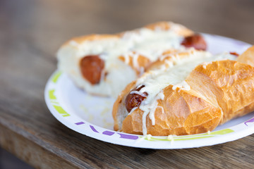 Hot dog with cheese on top