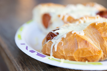 Hot dog with cheese on top