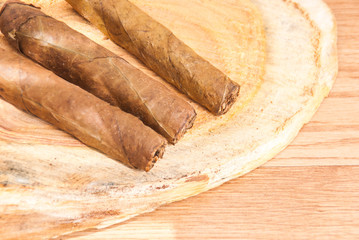 cigar of tobacco on the wooden background