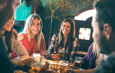 Group of happy friends drinking beer at brewery bar restaurant - Friendship concept with young...