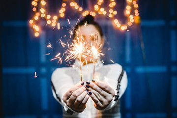 Young Woman Holding Sparkles Celebrating 