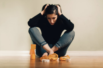 Caucasian female contemplating take prescription pills
