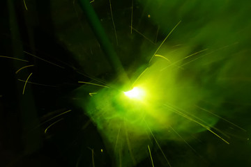 Metal pipe during welding. Sparks and scale