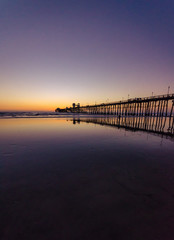 pier during colorful sunset in Oceanside, California, USA