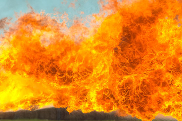 Flame tongues from the flamethrower. background of fire