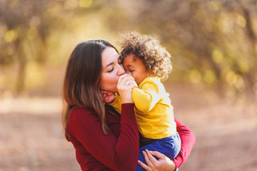 Happy Caucasian white mother holding 18-month baby