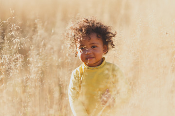 Happy boy child is smiling enjoying adopted life. Portrait of young boy in nature, park or outdoors. Concept of happy family or successful adoption or parenting.