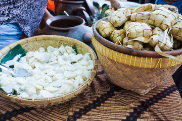 sliced ketupat in big bamboo bowl in traditional food market in central java