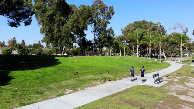 Fly by cross country runners who are walking at Mason Park in Irvine, CA