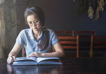 women read book to learning on bed in bed room in the morning