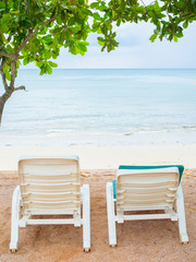 Empty white plastic sunbeds on sand  beach