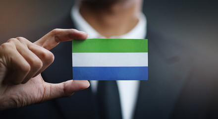 Businessman Holding Card of Sierra Leone Flag