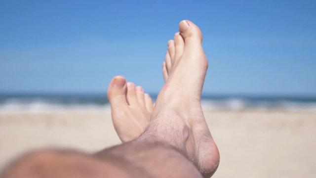 Man lying on the beach in 4k resolution slow motion 60fps