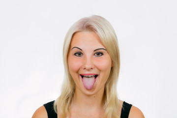 Fototapeta premium Female face with tongue out close-up