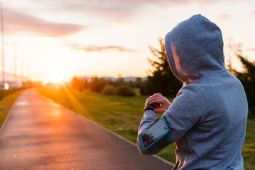 Woman athlete using smart watch activity tracker gps during running training.