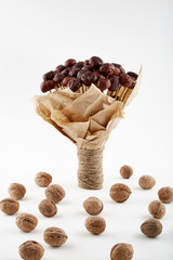 Bouquet made of chestnuts in craft paper with walnuts