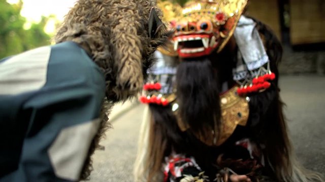 Asian artistic Balinese traditional dancers in ceremonial dragon and monkey masks performing Indonesia South East Asia