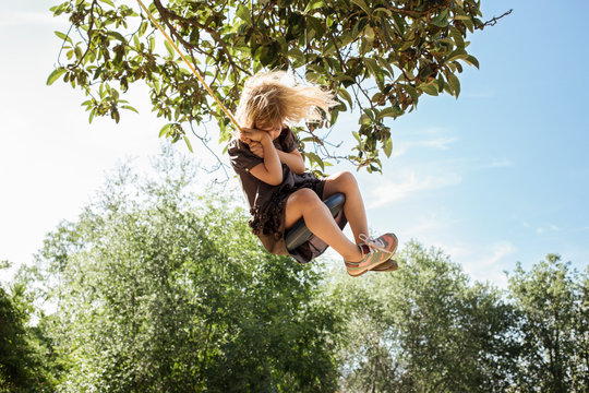 Girl on rope swing