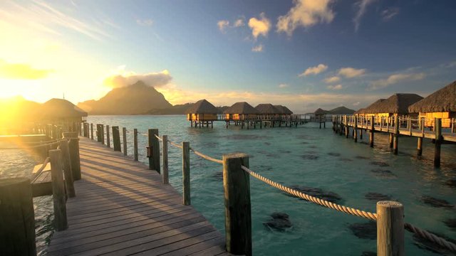 View of tropical lagoon with luxury Overwater Bungalows at sunrise in Bora Bora a French Polynesian Paradise South Pacific