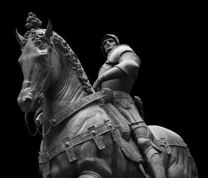 Sculpture of man on a horse isolated on black