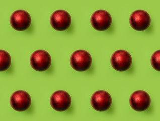 Red Christmas ball pattern on green background