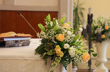 bible and floral decorations on an altar of the Christian churc