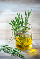 Bottle of extra virgin olive oil with rosemary.