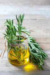 Bottle of extra virgin olive oil with rosemary.