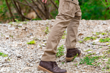 Man wearing cargo pants and climbing on the rock