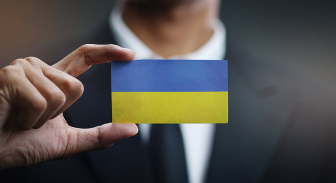 Businessman Holding Card of Ukraine Flag