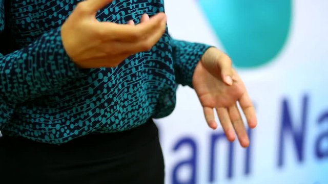 Hands of woman interlocutor during tv interview close up. Young woman move his hands while giving an interview. Hands of interlocutor