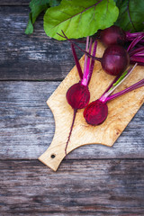 Fresh, organic raw beetroot against a wooden background.
