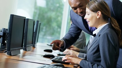 Multi ethnic business managers using computer technology and planning future projects 