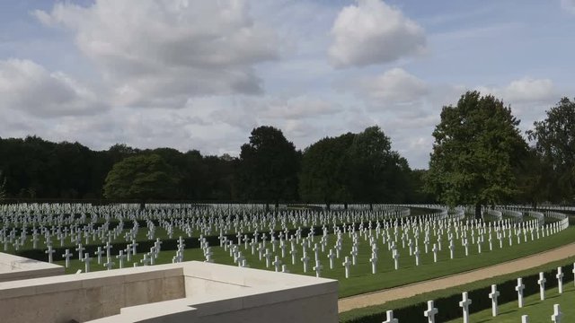 Zoom across terrace to rows of white crosses marking American graves at American WWII Cemetery Cambridge, England