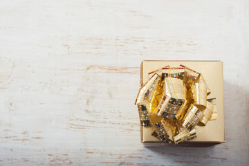 gold gift box on white table.