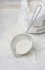 Sack with flour and sieve