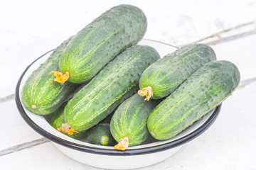Fresh cucumbers on wooden background.
