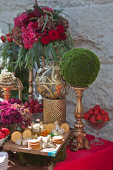 event reception with appetizers, caviar and crackers, cheese and fruit decorated with flowers
