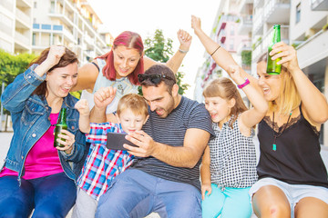 group of friends triumphing watching the mobile phone