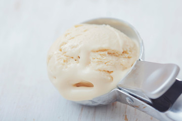 Homemade creamy ice cream in metal  scoop.